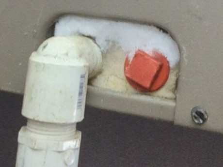 image of an ac drain line clogged because of ice